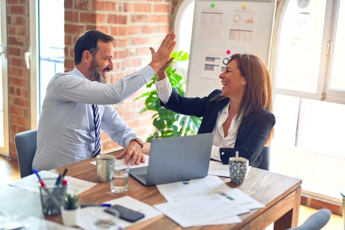 Business owner reviewing employee health benefits with an insurance consultant
